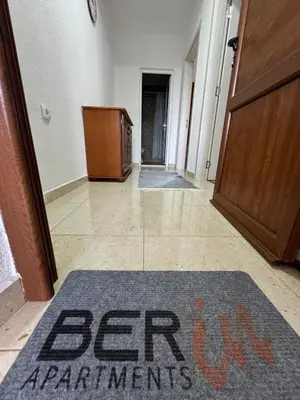 an entry hallway with a sign on a mat on the floor at Berin Apartments in Ulcinj