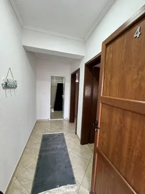 an empty hallway with a door and a carpet at Berin Apartments in Ulcinj