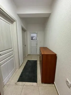 an empty hallway with a wooden cabinet and a door at Berin Apartments in Ulcinj