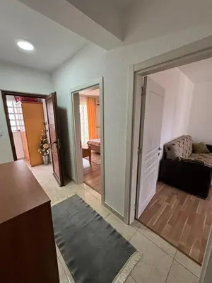 a living room with a door open to a living room at Berin Apartments in Ulcinj