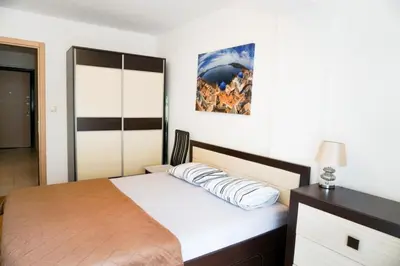 a bedroom with a bed and a picture on the wall at Apartment Marija in Budva