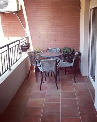 a patio with tables and chairs on a balcony at Apartment Marija in Budva