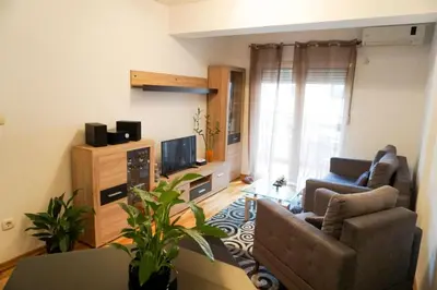 a living room with a couch and a television at Apartment Marija in Budva