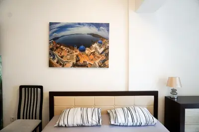 a bedroom with a bed and a painting on the wall at Apartment Marija in Budva
