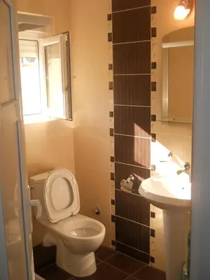 a bathroom with a toilet and a sink at Apartments Brnjada in Sutomore
