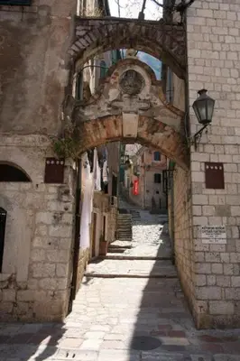 an alley with an archway in an old building at Apartment Ozana in Kotor