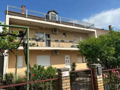 an apartment building with a balcony and a fence at Prestige 3 in Podgorica