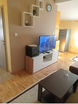 a living room with a flat screen tv on a cabinet at Prestige 3 in Podgorica