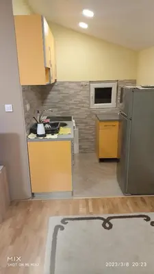 an empty kitchen with a refrigerator and a microwave at Prestige 3 in Podgorica