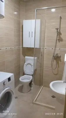 a bathroom with a toilet and a sink and a shower at Prestige 3 in Podgorica