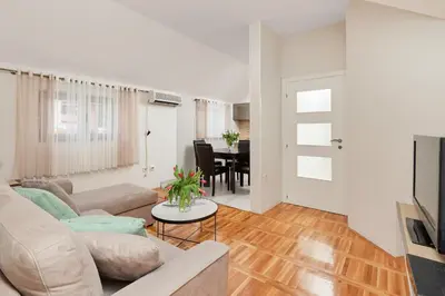 a living room with a couch and a table at Apartment Mrsulja in Kotor