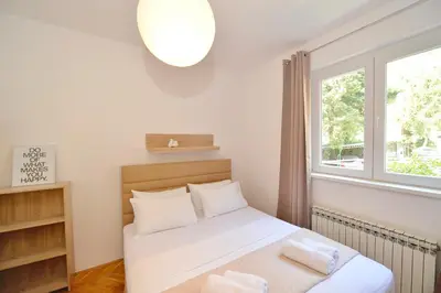 a small bedroom with a bed and a window at Seafront Apartments House 44 Private Balcony Old Town View in Kotor