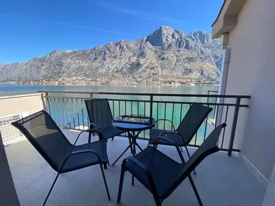 two chairs and a table on a balcony with a mountain at Seafront Apartments House 44 Private Balcony Old Town View in Kotor