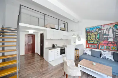 a kitchen and a living room with a blue couch at Seafront Apartments House 44 Private Balcony Old Town View in Kotor