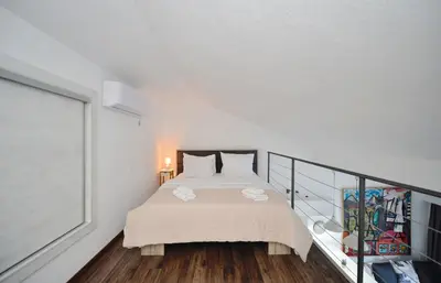 a white bedroom with a bed and a balcony at Seafront Apartments House 44 Private Balcony Old Town View in Kotor