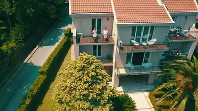 an aerial view of a house with people on the balcony at Seafront Apartments House 44 Private Balcony Old Town View in Kotor