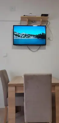 a flat screen tv hanging on a wall at Apartments Škaljari in Kotor