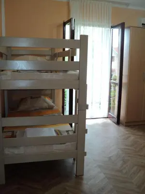 a bunk bed in a room with a window at Apartments Škaljari in Kotor