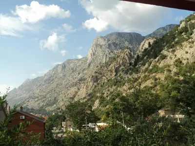 a mountain view of a town in front of a mountain at Apartments Škaljari in Kotor