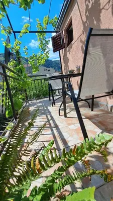a bench sitting on a patio next to a building at Apartments Škaljari in Kotor