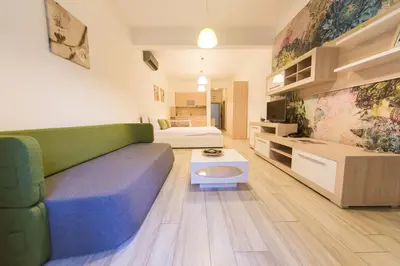 a living room with a couch and a bed at Apart Hotel Sea Fort in Sutomore