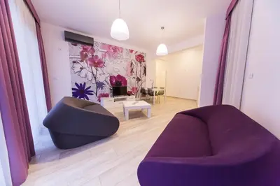 a living room with two chairs and a couch at Apart Hotel Sea Fort in Sutomore