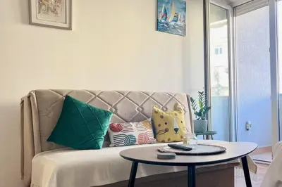 a living room with a couch and a table at Studio 6 in Podgorica