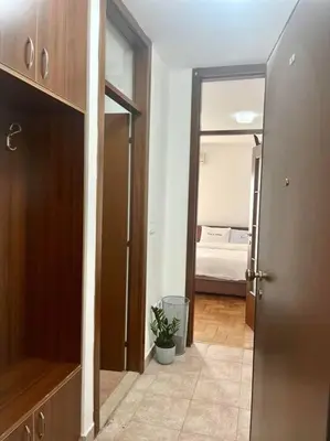 a hallway with a door leading to a bedroom at Studio 6 in Podgorica