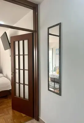 a room with a door and a mirror on the wall at Studio 6 in Podgorica