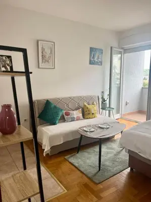 a living room with a couch and a table at Studio 6 in Podgorica