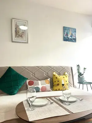 a table with two glasses on top of a couch at Studio 6 in Podgorica