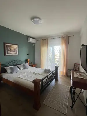a bedroom with a large bed and a window at Guesthouse HHL - Liman ll in Ulcinj