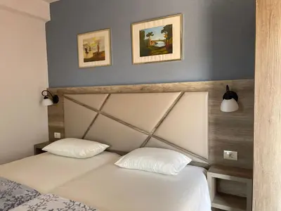 a bedroom with a white bed with two pillows at Guesthouse HHL - Liman ll in Ulcinj