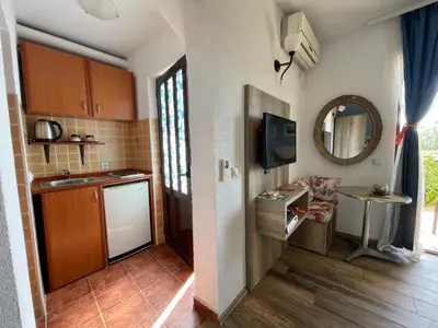 a small kitchen with a sink and a mirror at Guesthouse HHL - Liman ll in Ulcinj