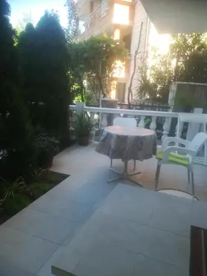 a patio with a table and chairs on a patio at Apartments Dijana in Budva