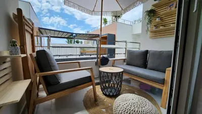a small balcony with a couch and a table at Marelis condo with sea view in Ulcinj