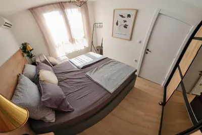 a bedroom with a bed with a laptop on it at Marelis condo with sea view in Ulcinj