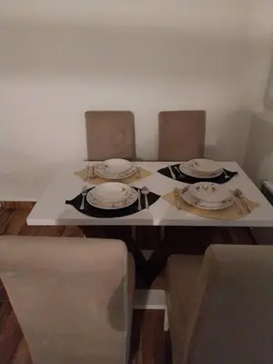 a table with plates and napkins on top of it at Obilex in Podgorica