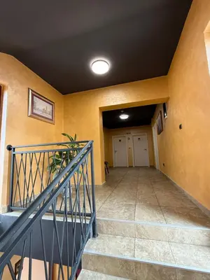 a hallway of a house with a staircase and yellow walls at Zeta Lux in Mitrovići