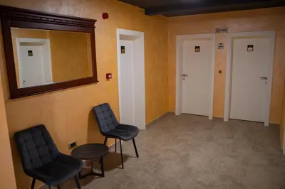 a waiting room with two chairs and a mirror at Zeta Lux in Mitrovići