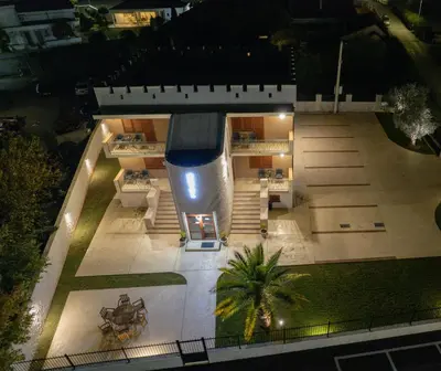 an aerial view of a house with a pool at night at Zeta Lux in Mitrovići