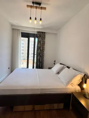 a bedroom with a large bed and a window at Kabaseo Spa in Becici