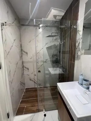 a shower with a glass door in a bathroom at Kabaseo Spa in Becici
