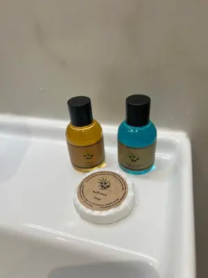 two bottles ofodorizers sitting on a white shelf at Kabaseo Spa in Becici
