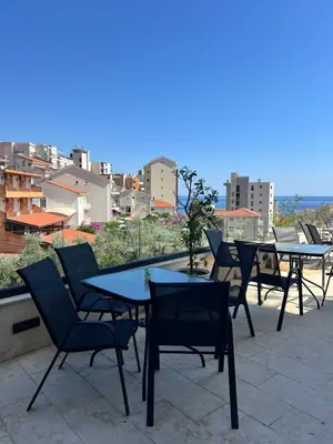 a group of tables and chairs sitting on a roof at Kabaseo Spa in Becici