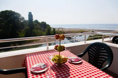 a table with a red and white checkered table cloth at Apartments Art in Ulcinj