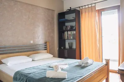 a bedroom with a bed with towels on it at Apartments Art in Ulcinj