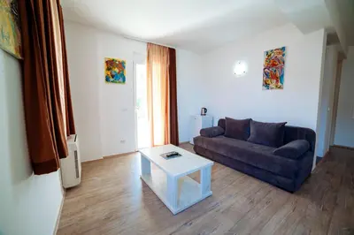 a living room with a couch and a table at Apartments Art in Ulcinj