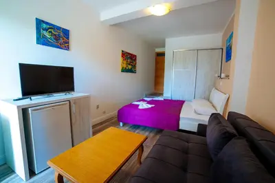 a living room with a couch and a bed at Apartments Art in Ulcinj