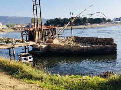 a boat sitting in the water next to a dock at Apartments Art in Ulcinj